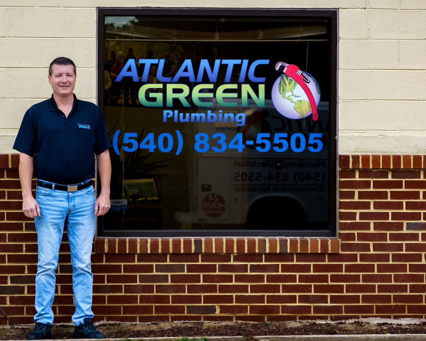 Outside the Atlantic Green Plumbing shop window, with the phone number (540) 834-5505 painted on the glass